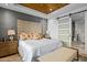 Comfortable bedroom with wood-look floors, panel wall, sliding glass door, and ensuite bathroom at 37200 N Cave Creek Rd # 1122, Scottsdale, AZ 85262