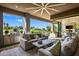 Inviting outdoor living area with golf course views, built-in grill, and plush seating at 37200 N Cave Creek Rd # 1122, Scottsdale, AZ 85262