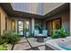 Private courtyard featuring hot tub, fire pit, modern patio furniture and lush landscaping at 37200 N Cave Creek Rd # 1122, Scottsdale, AZ 85262