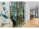 Modern wine storage area with glass enclosure, wooden racks, and temperature control at 37200 N Cave Creek Rd # 1122, Scottsdale, AZ 85262