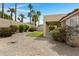 Scenic backyard with lawn, gravel groundcover, mature landscaping, and privacy wall at 4031 N Ranier --, Mesa, AZ 85215