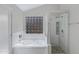 Bright bathroom with a tub, glass-enclosed shower, and modern finishes at 4031 N Ranier --, Mesa, AZ 85215