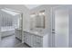 Bright bathroom with double vanity, large mirrors, and walk-in tub at 4031 N Ranier --, Mesa, AZ 85215