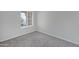 This bedroom features neutral carpet, grey walls, and a window providing natural light at 4031 N Ranier --, Mesa, AZ 85215