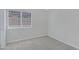 This bedroom features neutral carpet, grey walls, and a window providing natural light at 4031 N Ranier --, Mesa, AZ 85215