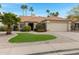 Charming single-story home with desert landscaping, a tile roof, and a two-car garage at 4031 N Ranier --, Mesa, AZ 85215