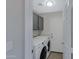 This laundry room has a washer, dryer, and built-in shelving for convenient storage at 4031 N Ranier --, Mesa, AZ 85215