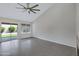 Living room with sliding glass door, ceiling fan, and tile flooring at 4031 N Ranier --, Mesa, AZ 85215