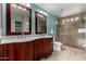 Spacious bathroom with double vanity, granite countertops, and glass-enclosed shower at 4525 E Desert View Dr, Phoenix, AZ 85044
