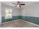 Cozy bedroom featuring wood-look floors, two-tone walls, and modern ceiling fan at 4525 E Desert View Dr, Phoenix, AZ 85044