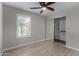 This bedroom features a ceiling fan, wood floors, a closet, and a window with shutters at 4525 E Desert View Dr, Phoenix, AZ 85044
