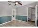 Bedroom with wood-look floors, two-tone walls, and built in closet with shelving at 4525 E Desert View Dr, Phoenix, AZ 85044