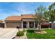 Inviting home exterior showcasing a well-maintained lawn and attractive landscaping, plus a two-car garage at 4525 E Desert View Dr, Phoenix, AZ 85044