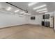 Spacious 2 car garage featuring epoxy floors, storage, and an air conditioning unit at 4525 E Desert View Dr, Phoenix, AZ 85044