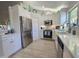 Well-lit kitchen featuring white cabinets, stainless steel appliances, and quartz countertops at 4525 E Desert View Dr, Phoenix, AZ 85044