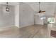 Bright living room with ceiling fan, and wood-style tile flooring at 4525 E Desert View Dr, Phoenix, AZ 85044