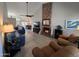 Spacious living room featuring a brick fireplace, vaulted ceilings, and contemporary furnishings at 4525 E Desert View Dr, Phoenix, AZ 85044