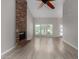 Open living room with brick fireplace and large windows at 4525 E Desert View Dr, Phoenix, AZ 85044