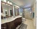 Bathroom with a double sink vanity, a walk-in shower, and updated fixtures at 4525 E Desert View Dr, Phoenix, AZ 85044