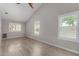 Bright bedroom featuring wood-look floors, three large windows and vaulted ceilings at 4525 E Desert View Dr, Phoenix, AZ 85044