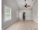Bright bedroom featuring vaulted ceilings, wood-look floors and bathroom access at 4525 E Desert View Dr, Phoenix, AZ 85044