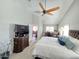 Bright main bedroom featuring vaulted ceilings, a ceiling fan, and a large television at 4525 E Desert View Dr, Phoenix, AZ 85044