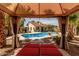 Backyard pool view from shaded lounge area with manicured landscaping and desert scenery at 4525 E Desert View Dr, Phoenix, AZ 85044