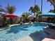 Inviting pool area with tropical landscaping, umbrellas, and ample space for relaxation and entertainment at 4525 E Desert View Dr, Phoenix, AZ 85044