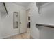 Walk-in closet featuring wood-look floors and custom storage shelves and open door to bathroom at 4525 E Desert View Dr, Phoenix, AZ 85044