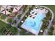 Aerial view of the pool and playground, surrounded by lush landscaping, creating a resort-style community at 46378 W Lander Ln, Maricopa, AZ 85139