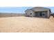 Unlandscaped dirt backyard with block wall and back patio at 46378 W Lander Ln, Maricopa, AZ 85139