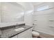 Well-lit bathroom featuring a vanity, tub-shower combo, and a large mirror at 46378 W Lander Ln, Maricopa, AZ 85139