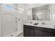 Clean bathroom with a double vanity, modern fixtures, and a bright shower at 46378 W Lander Ln, Maricopa, AZ 85139