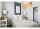 Comfortable bedroom with soft decorative pillows, a blue accent wall, and soft lighting at 46378 W Lander Ln, Maricopa, AZ 85139
