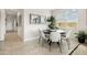 Bright dining area features a round table, comfortable seating, and ample natural light from a large window at 46378 W Lander Ln, Maricopa, AZ 85139