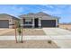 Charming single-story home with a gray color palette, a well-kept yard and a two car garage at 46378 W Lander Ln, Maricopa, AZ 85139