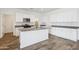 Contemporary kitchen featuring white cabinets, granite countertops, a central island, and stainless steel appliances at 46378 W Lander Ln, Maricopa, AZ 85139