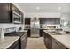 Contemporary kitchen featuring stainless steel appliances and a marble countertop island at 46378 W Lander Ln, Maricopa, AZ 85139