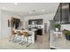 Modern kitchen with stainless steel appliances, marble countertops, and an island with bar seating at 46378 W Lander Ln, Maricopa, AZ 85139