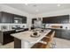 Modern kitchen with stainless steel appliances, marble countertops, and an island at 46378 W Lander Ln, Maricopa, AZ 85139