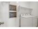 Clean laundry room with white appliances and shelving, ready for chores at 46378 W Lander Ln, Maricopa, AZ 85139