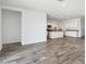 Open-concept living room with a kitchen featuring stainless steel appliances and a tiled floor at 46378 W Lander Ln, Maricopa, AZ 85139