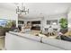 Open-concept living space with modern decor, kitchen view, and a comfortable gray sofa at 46378 W Lander Ln, Maricopa, AZ 85139