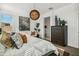 Bright main bedroom with stylish decor, a comfortable bed, and ample natural light from a large window at 46378 W Lander Ln, Maricopa, AZ 85139