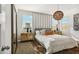 Cozy main bedroom with natural lighting, stylish nightstands, and a comfortable bed with decorative pillows at 46378 W Lander Ln, Maricopa, AZ 85139