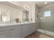 An elegant bathroom with double vanity sinks and a tiled glass enclosed shower at 5100 E Rancho Paloma Dr # 2078, Cave Creek, AZ 85331
