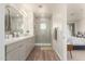 Bathroom with a tiled shower and double vanity sinks, adjacent to a bedroom at 5100 E Rancho Paloma Dr # 2078, Cave Creek, AZ 85331