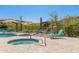 Community hot tub and pool area with lounge chairs and umbrellas for relaxation at 5100 E Rancho Paloma Dr # 2078, Cave Creek, AZ 85331