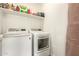 Efficient laundry area with modern washer, dryer, and convenient storage shelving at 5100 E Rancho Paloma Dr # 2078, Cave Creek, AZ 85331