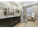 Bathroom featuring double sinks, a walk in shower and well organized closet space at 5237 W Alta Mesa Ave, Laveen, AZ 85339